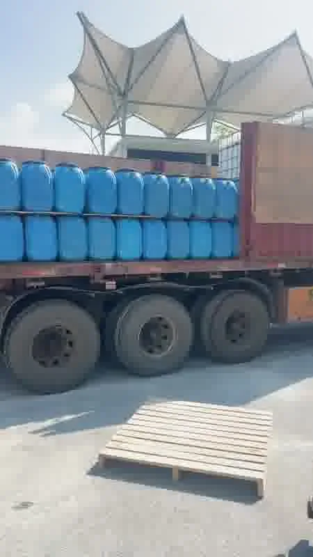 Blue pails loaded onto a flatbed truck